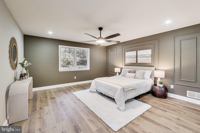 bedroom with ceiling fan and light hardwood / wood-style floors