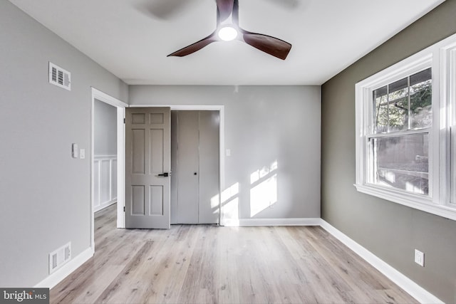 unfurnished bedroom featuring a closet, ceiling fan, and light wood-type flooring