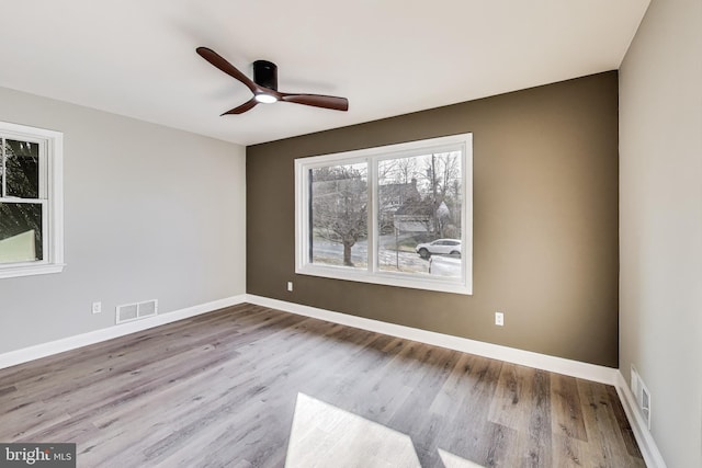 empty room featuring ceiling fan and light hardwood / wood-style flooring