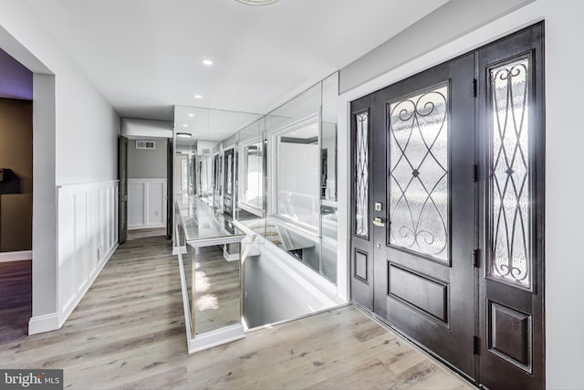 foyer with light hardwood / wood-style floors