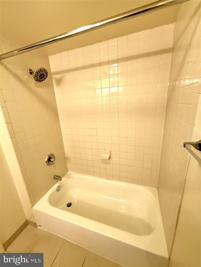 bathroom with bathing tub / shower combination and tile patterned floors