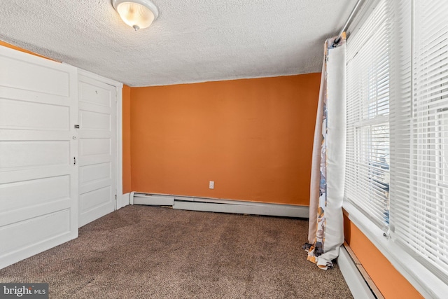 unfurnished bedroom featuring a baseboard radiator, carpet flooring, and a textured ceiling