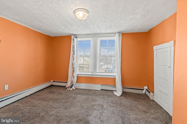 spare room with carpet flooring, a textured ceiling, and baseboard heating