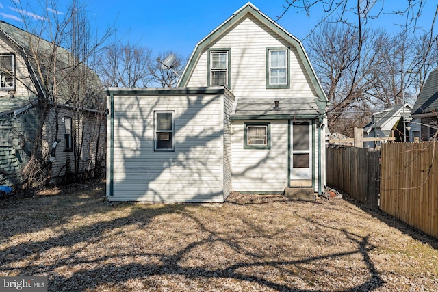 rear view of property with a lawn