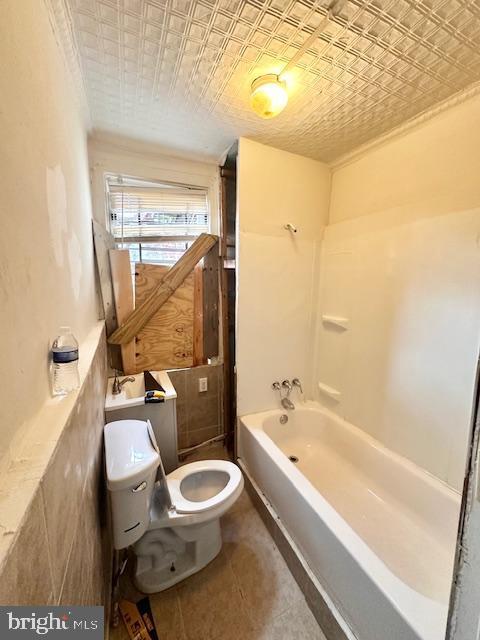 bathroom with toilet and an ornate ceiling