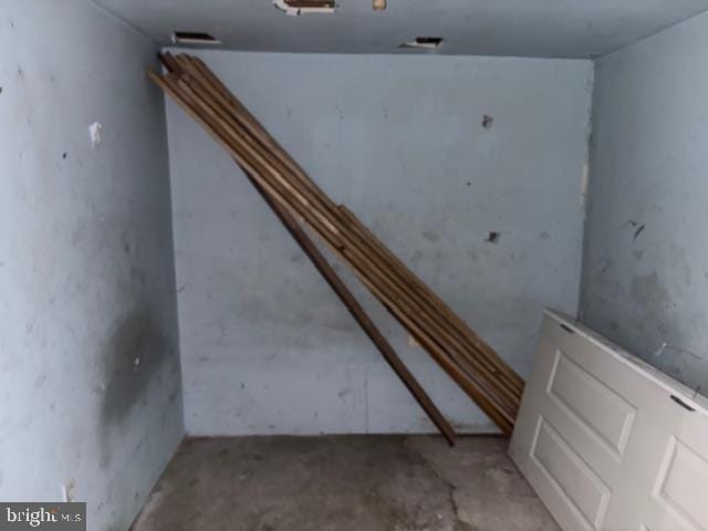 staircase with unfinished concrete floors