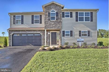 view of front of home featuring a garage and a front lawn