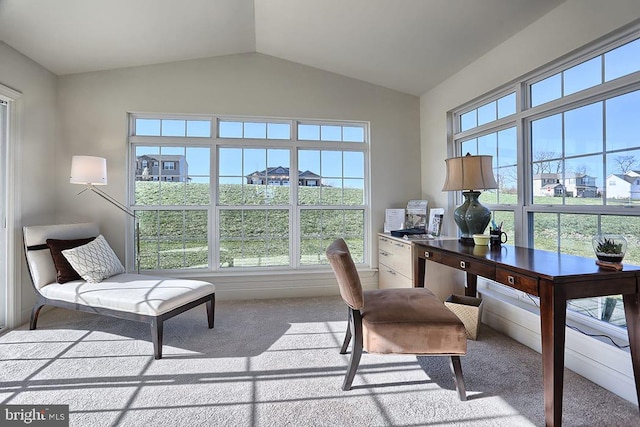 carpeted office featuring lofted ceiling