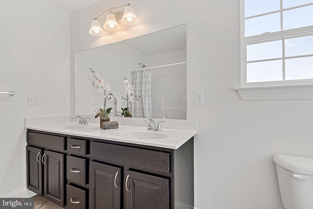 bathroom featuring vanity, a shower with shower curtain, and toilet