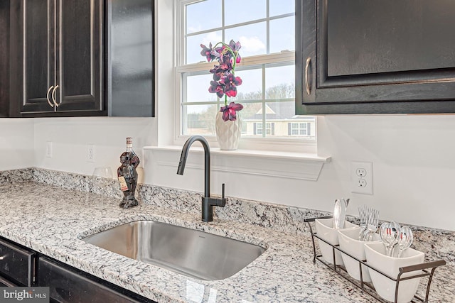 kitchen with sink and light stone countertops