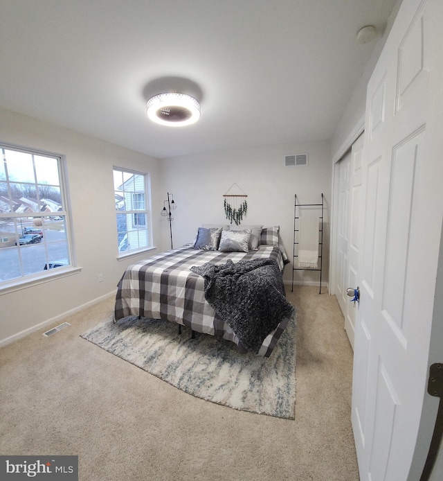 carpeted bedroom featuring a closet