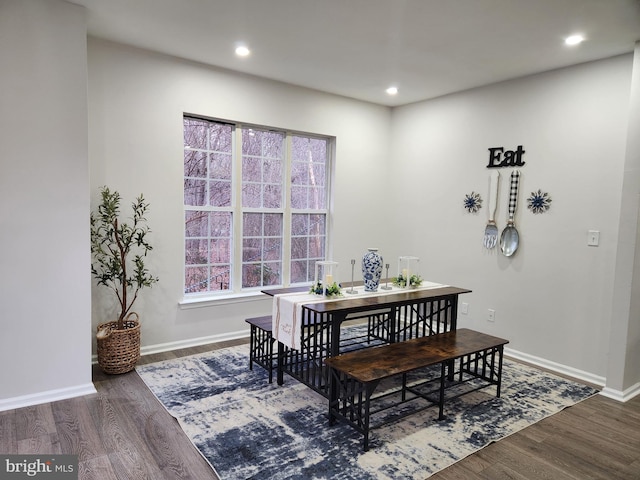 dining space with dark wood-type flooring