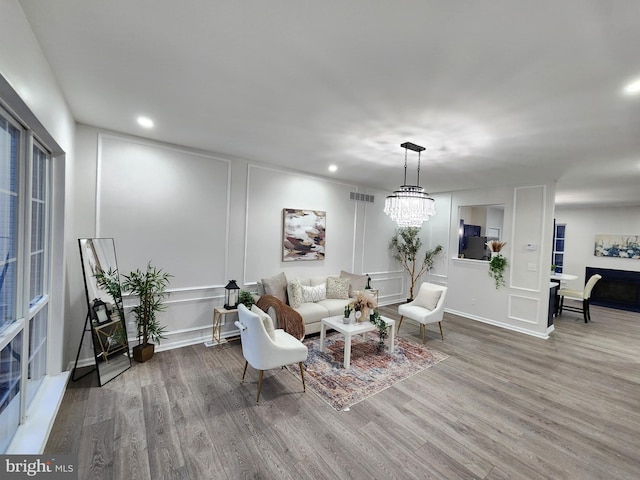 living room with hardwood / wood-style flooring and a chandelier