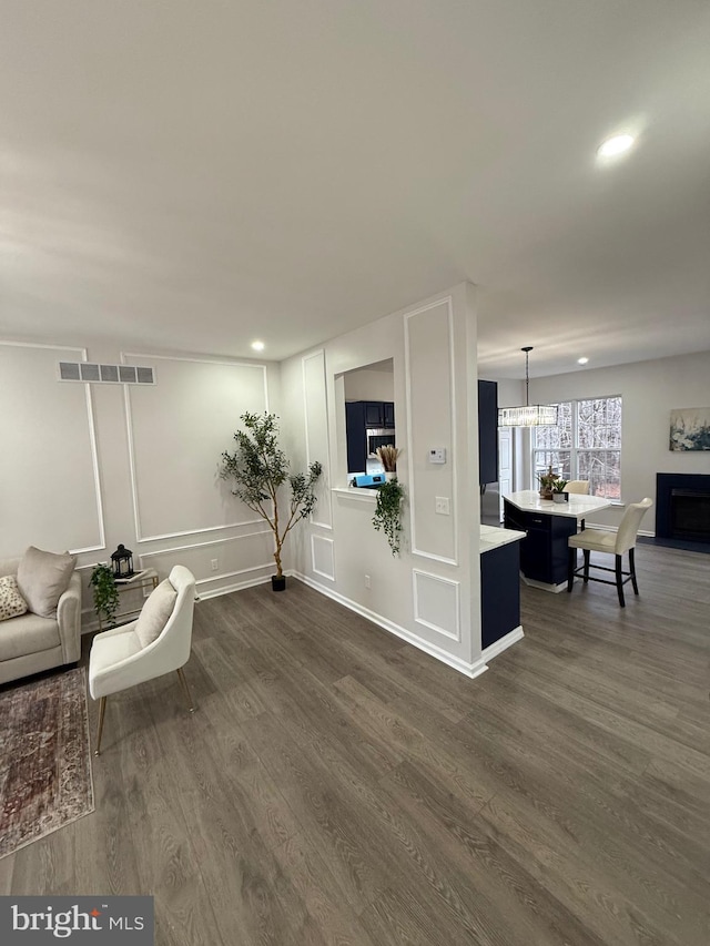 living room featuring dark hardwood / wood-style floors and a chandelier