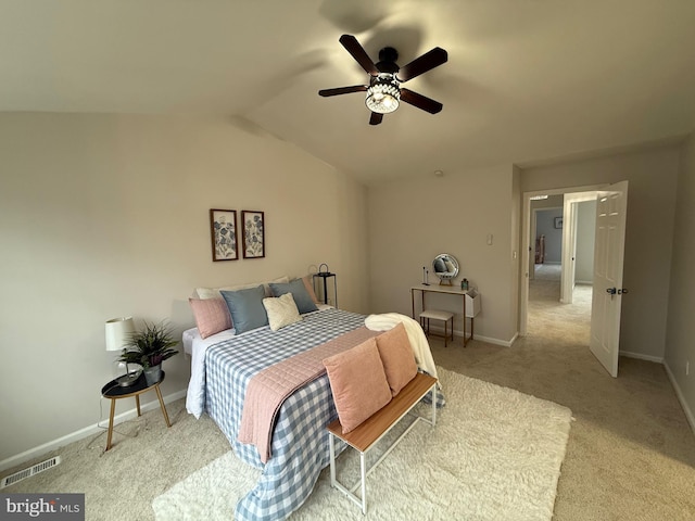 bedroom with lofted ceiling, light colored carpet, and ceiling fan