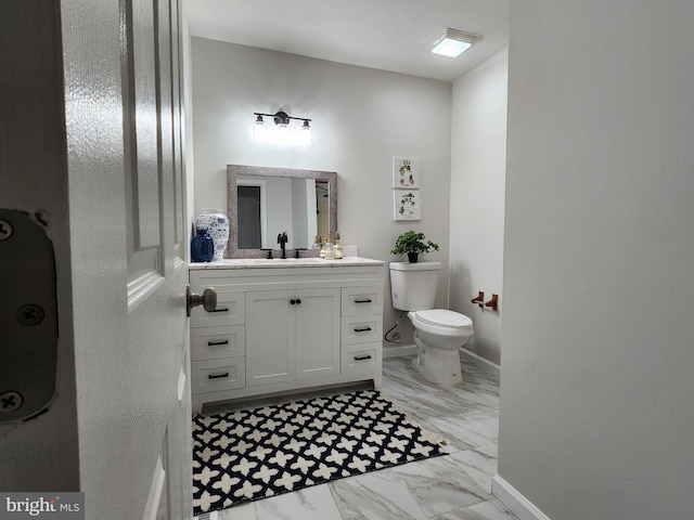 bathroom with vanity and toilet