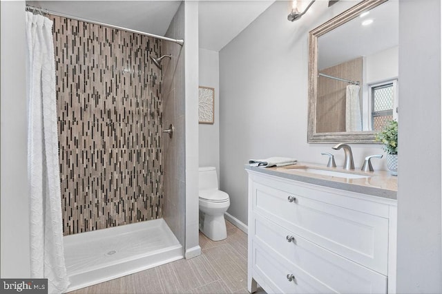 bathroom featuring tile patterned flooring, toilet, vanity, and a shower with shower curtain