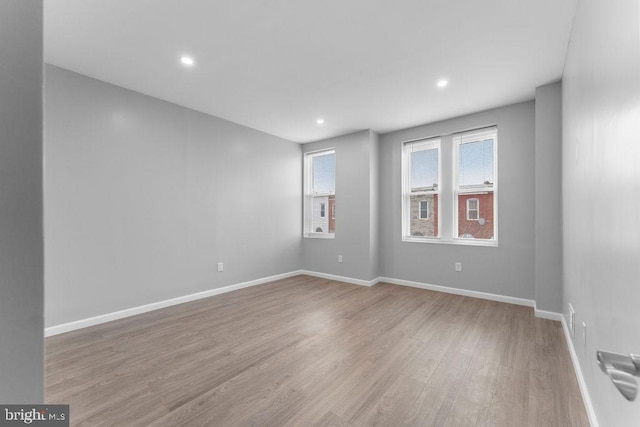 unfurnished room with light hardwood / wood-style flooring