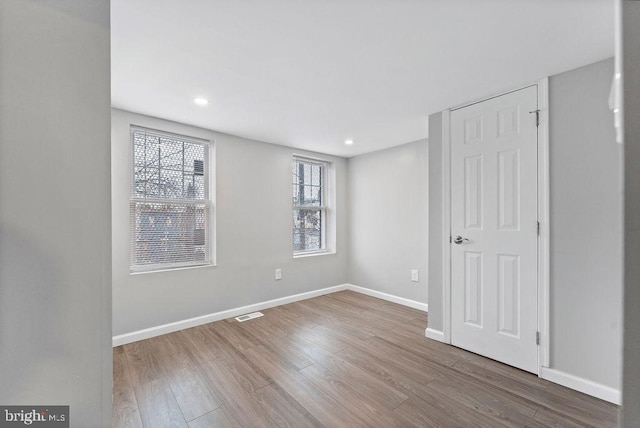 spare room with hardwood / wood-style floors