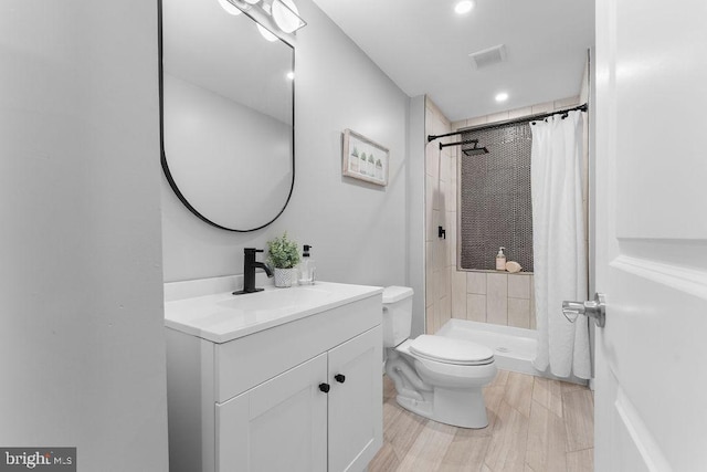 bathroom with vanity, curtained shower, and toilet