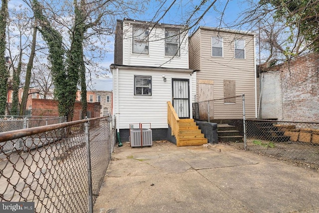 rear view of house featuring cooling unit