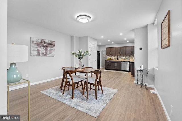 dining space featuring light wood-type flooring