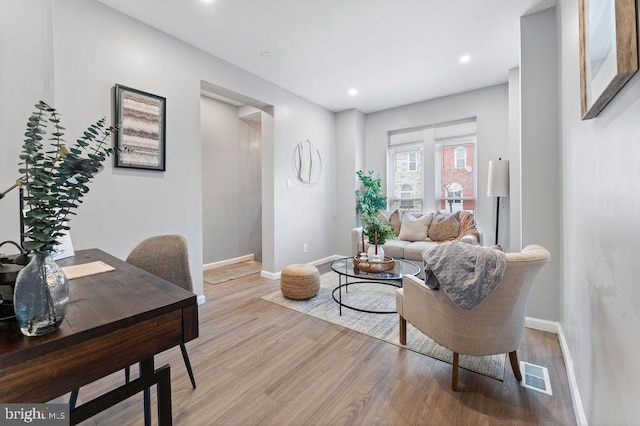 living room with light hardwood / wood-style flooring