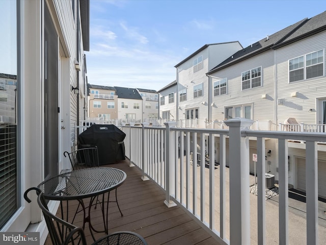 balcony with central AC unit, a residential view, and a grill