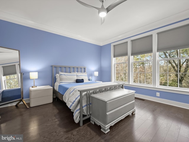 bedroom with dark wood-type flooring, a ceiling fan, baseboards, and ornamental molding