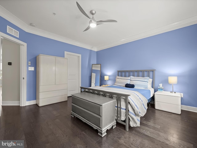 bedroom with visible vents, crown molding, baseboards, and wood finished floors