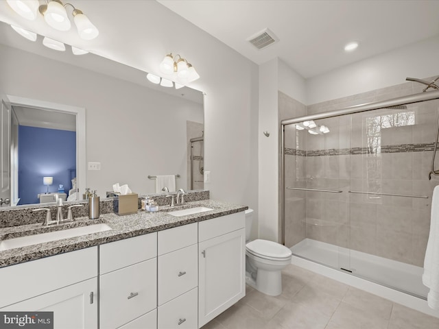 bathroom featuring a stall shower, visible vents, and a sink