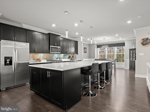 kitchen with dark cabinetry, a large island, light countertops, and stainless steel appliances