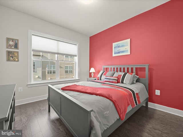 bedroom with baseboards and wood finished floors