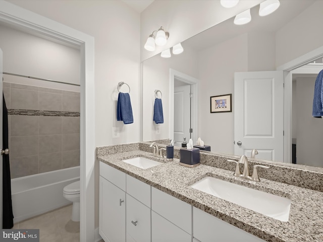 full bath with tile patterned flooring, double vanity, toilet, and a sink