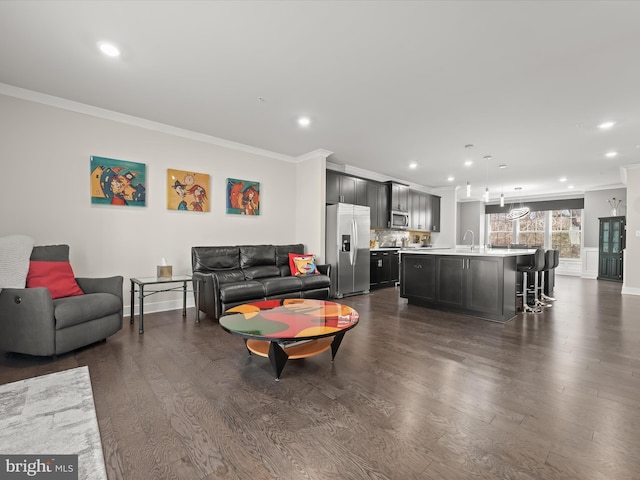 living room with recessed lighting, ornamental molding, and dark wood-style flooring