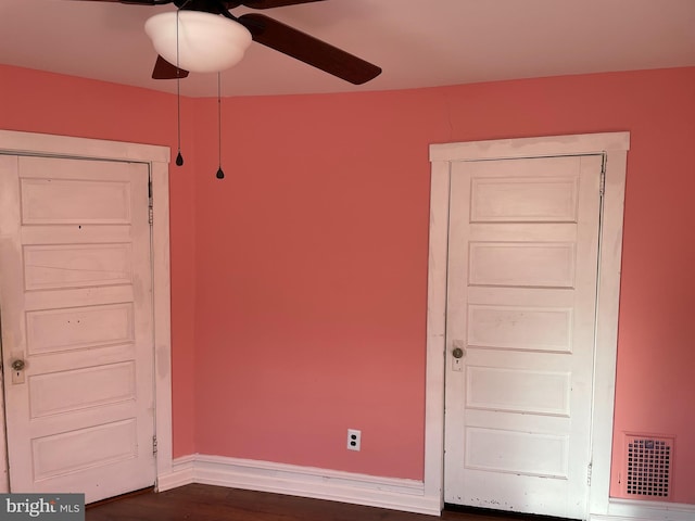 interior space with visible vents, baseboards, and dark wood-style flooring