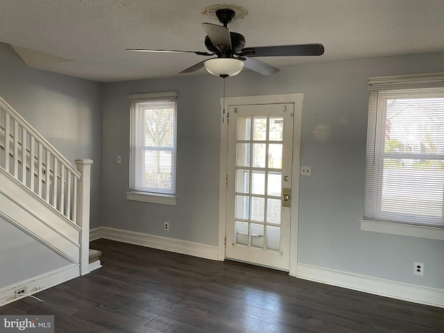 doorway with stairs, wood finished floors, and baseboards