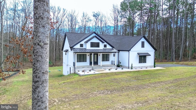 modern farmhouse style home with covered porch and a front lawn