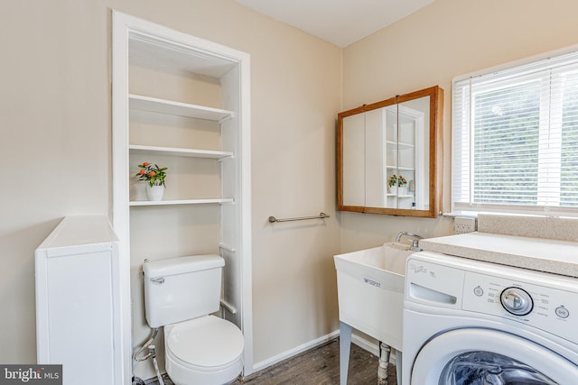 bathroom with sink, toilet, washer / dryer, and hardwood / wood-style floors