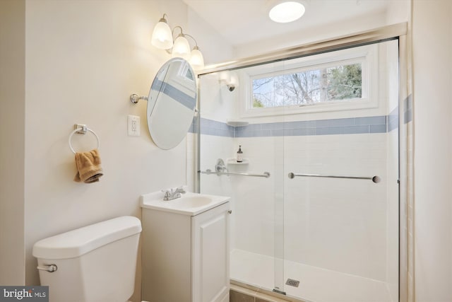 bathroom featuring walk in shower, vanity, and toilet