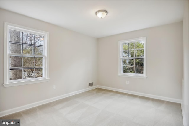 empty room featuring light colored carpet