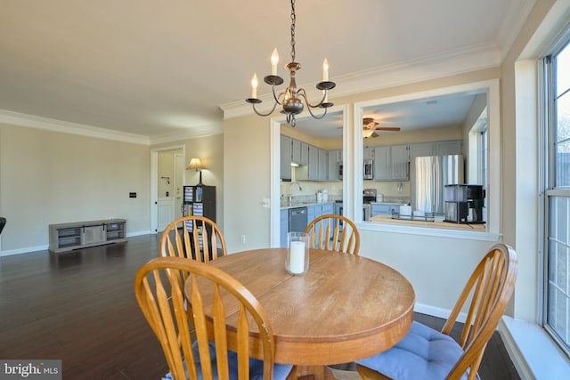 dining space with dark wood-style floors, baseboards, crown molding, and an inviting chandelier