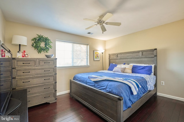 bedroom with dark wood-style flooring, visible vents, ceiling fan, and baseboards