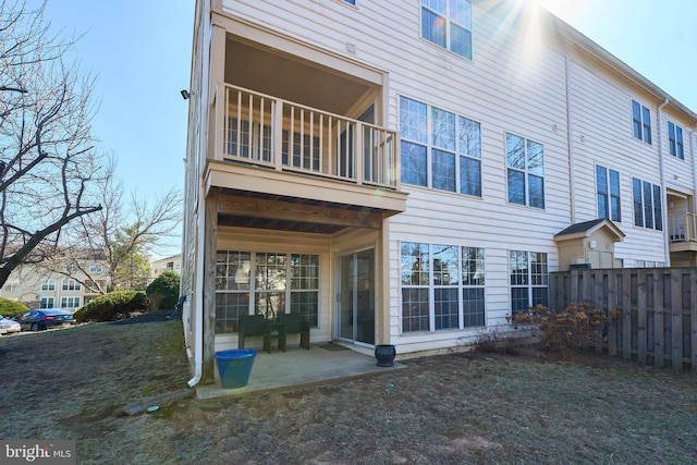 back of house featuring a patio, fence, and a balcony