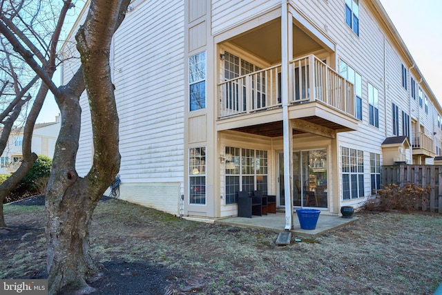 back of property with a patio, fence, and a balcony