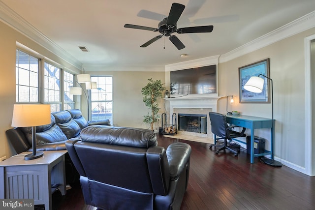 living room with dark wood-style floors, visible vents, crown molding, and a premium fireplace