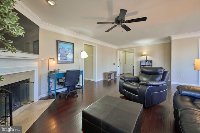 living room featuring wood-type flooring, a fireplace, and crown molding