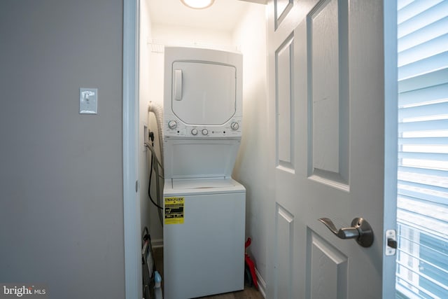 washroom featuring stacked washer / dryer