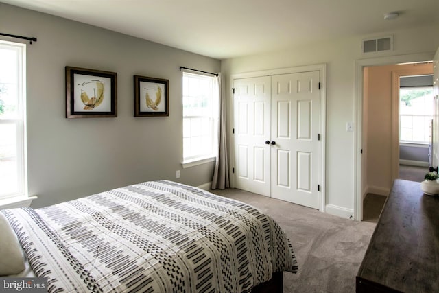 carpeted bedroom with a closet