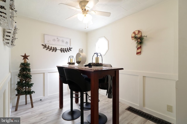 dining area with ceiling fan and light wood-type flooring